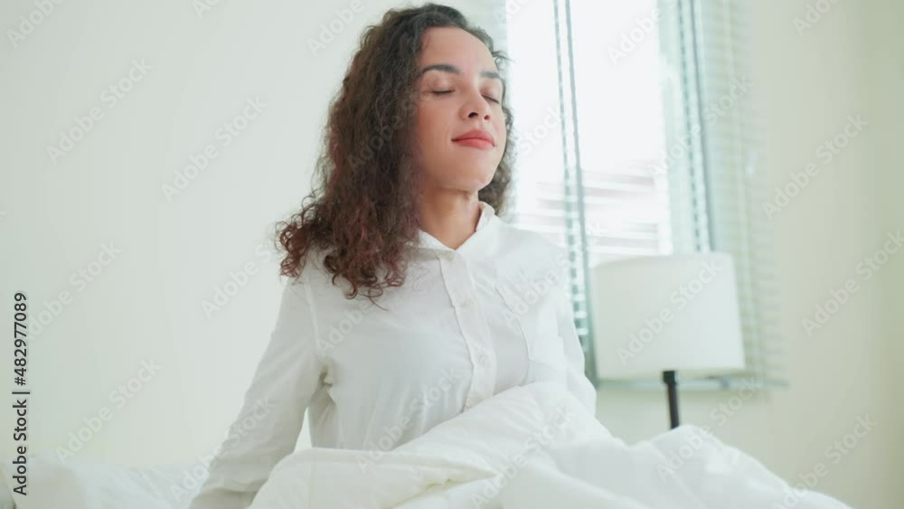 Beautiful Latino girl in pajamas wake up in the morning with happiness. Beautiful Latino girl in pajamas wake up in the morning with happiness.