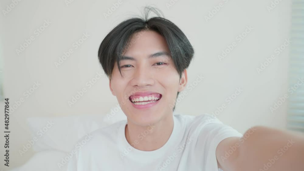 Asian handsome man gay use mobile phone video call online with family. Asian handsome man gay use mobile phone video call online with family.