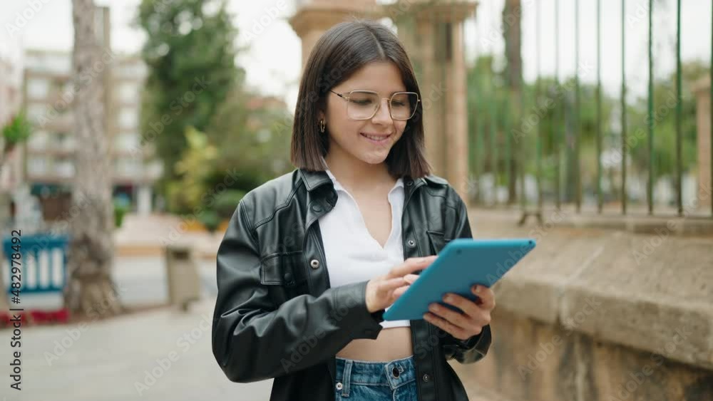 Young hispanic woman smiling confident using touchpad at street Young hispanic woman smiling confident using touchpad at street