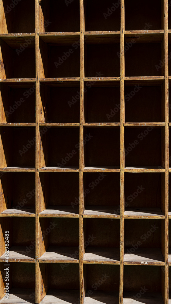 Empty wooden shelf background with hard shadows Empty wooden shelf background with hard shadows