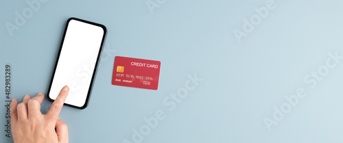 Hand touch blank screen mobile phone and credit card isolated on gray background, banner mock up, template, top view, flate lay, Business and technology