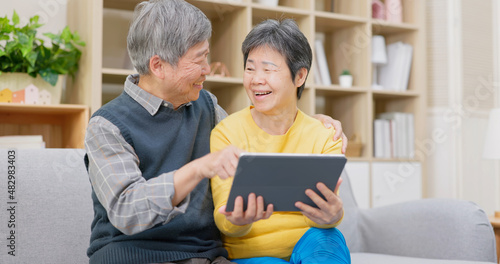 elderly couple use digital tablet