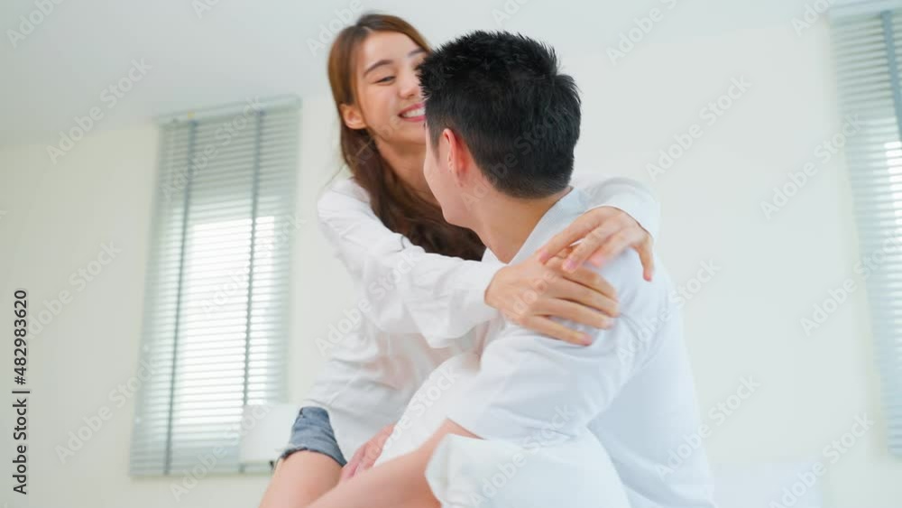 Portrait of Asian new marriage couple lying on bed and look each other. Portrait of Asian new marriage couple lying on bed and look each other.