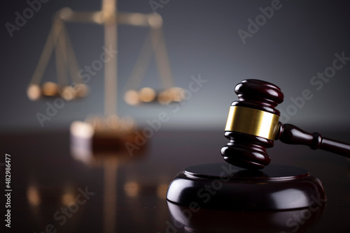 Law symbols composition. Law and justice concept.  Gavel and scale on gray background. photo