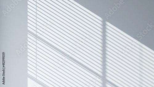 3D Render of beautiful window blind shadow from morning sunlight on grey empty wall inside the room. Background, Product presentation, Backdrop, Mockup, Interior, Shade and shadow, Lining, Abstract.