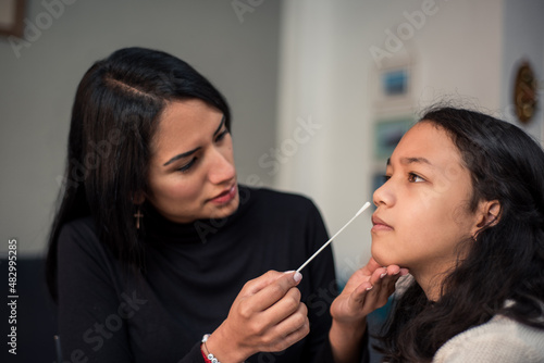 Photography Mother doing auto test antigen nasal swab test stick to detect possible covid