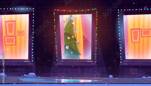 House facade with windows and Christmas tree inside. Vector cartoon illustration of residential building exterior, snow, holiday garlands on brick wall and Xmas fir in home