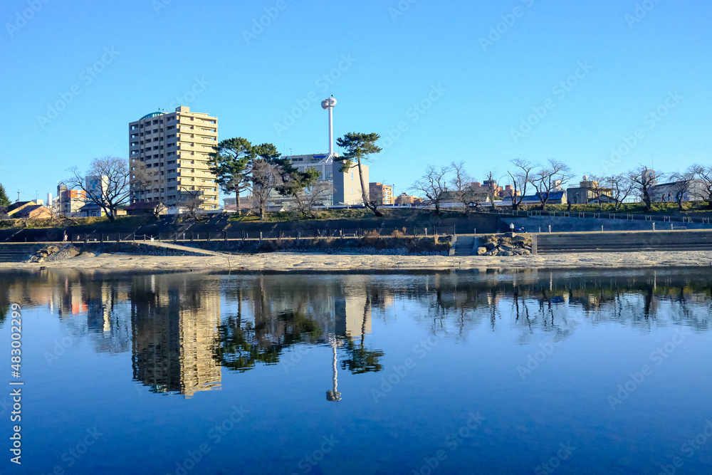 Naklejka premium A beautiful view of the downtown skyline of Okazaki, reflecting in the Otagawa River below. Architectural scenery around Okazaki park, Shizuoka, Japan