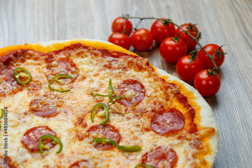 pizza with salami, mozarella, green hot pepper