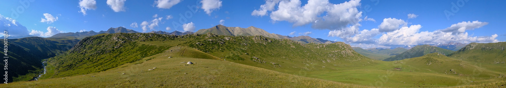 Beautiful mountain valley landscape with cloudy sky on background. Nature landscape. Sky background. Summer vacation.