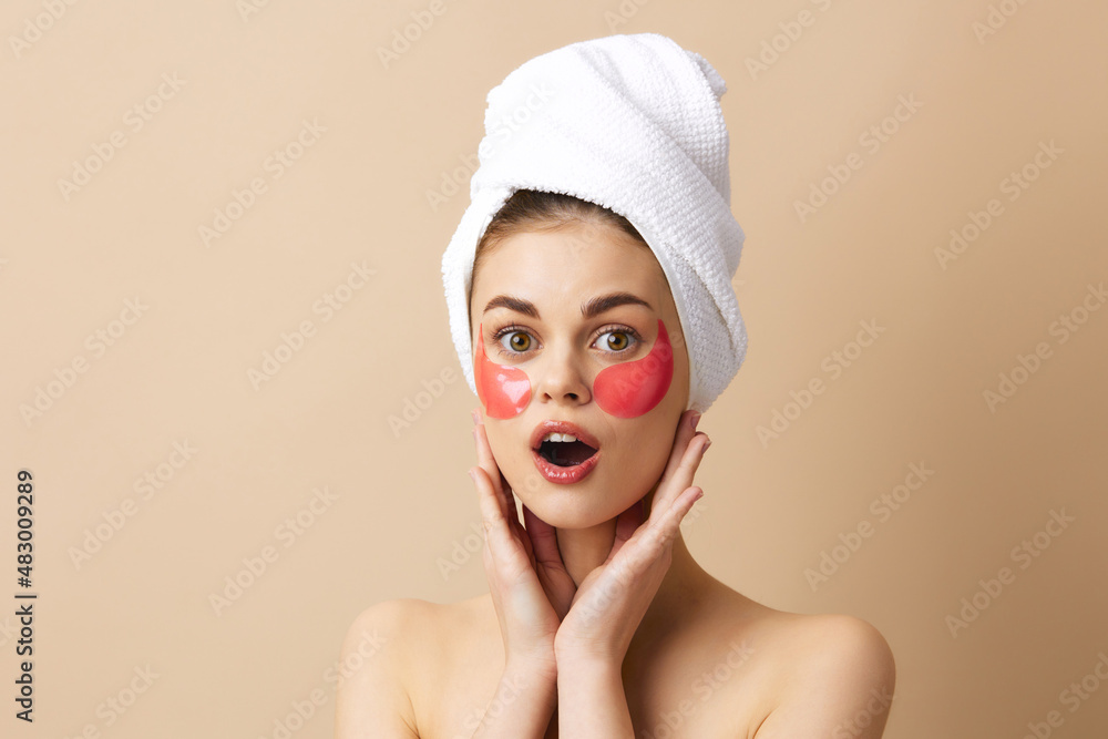 young woman pink patches on the face with a towel on the head close-up Lifestyle young woman pink patches on the face with a towel on the head close-up Lifestyle