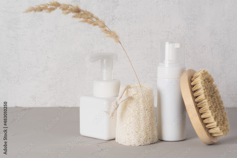 Spa cosmetic products and eco friendly bathroom accessories on gray texture background. Beauty, spa and wellness concept. Spa cosmetic products and eco friendly bathroom accessories on gray texture background. Beauty, spa and wellness concept.