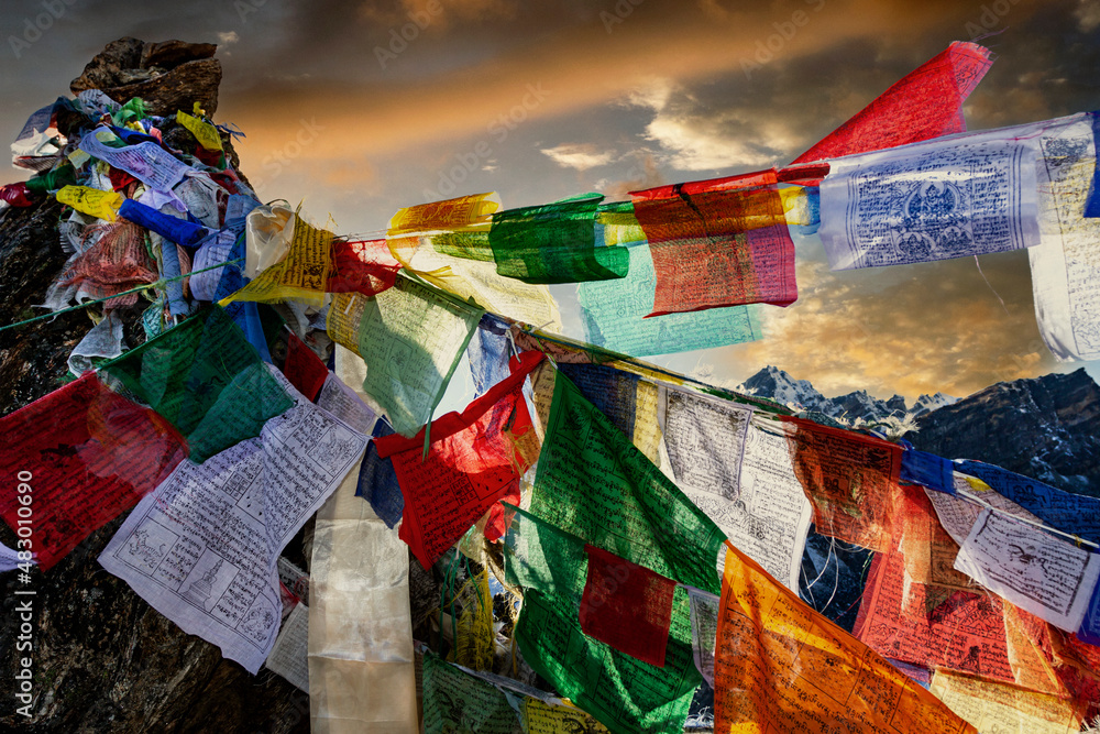 Prayer flags are blowing in the wind on the Renjo La pass, 5430 m., in Nepal