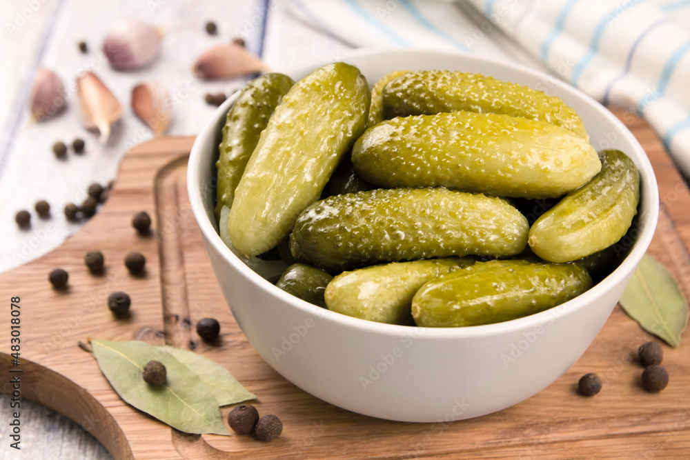 Pickled cucumbers in a bowl on a wooden rustic table Pickled cucumbers in a bowl on a wooden rustic table