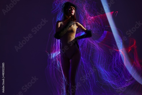 Portrait of a charming lady neon lines light posing color background unaltered