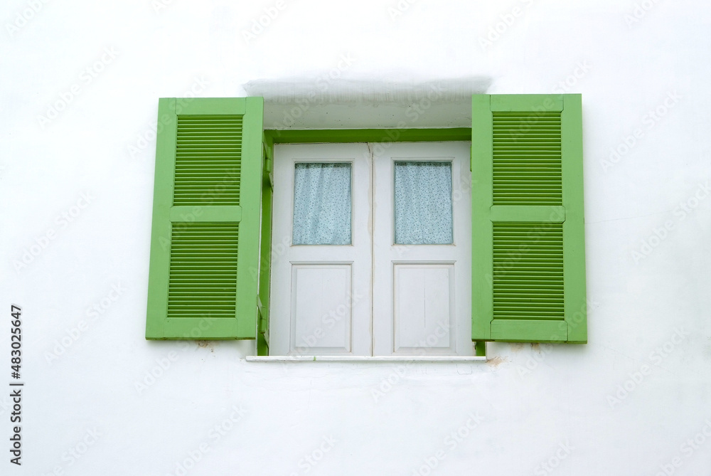 Green window on the white wall Green window on the white wall
