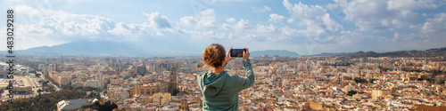 woman traveler taking photography on city landscape of Malaga- Andalusia in Spain