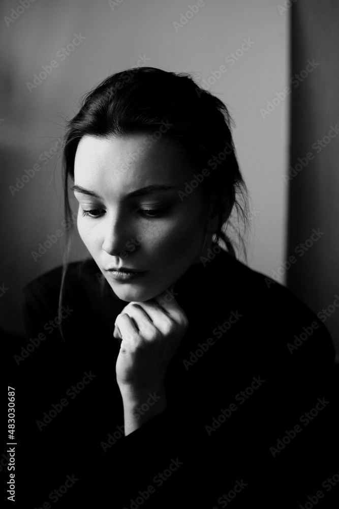 Fototapeta premium Black and white portrait of young beautiful woman in profile