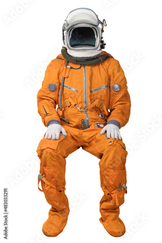 Tableau sur toile Astronaut wearing an orange spacesuit and open space helmet sitting isolated on