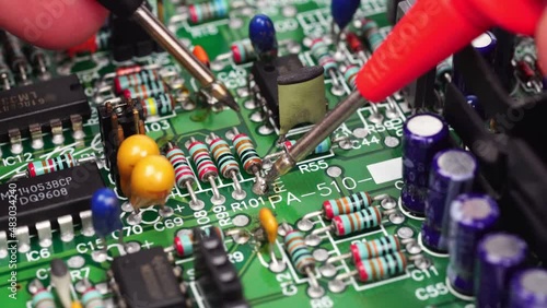 The hand of the engineer measures the voltage on the electrical board with the test leads of the multimeter. Closeup.                           