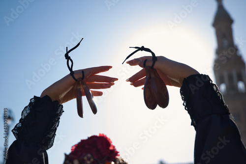 Detail of hands of young flamenco woman, playing castanets. Concept of flamenco, dancer, typical Spanish dance. photo