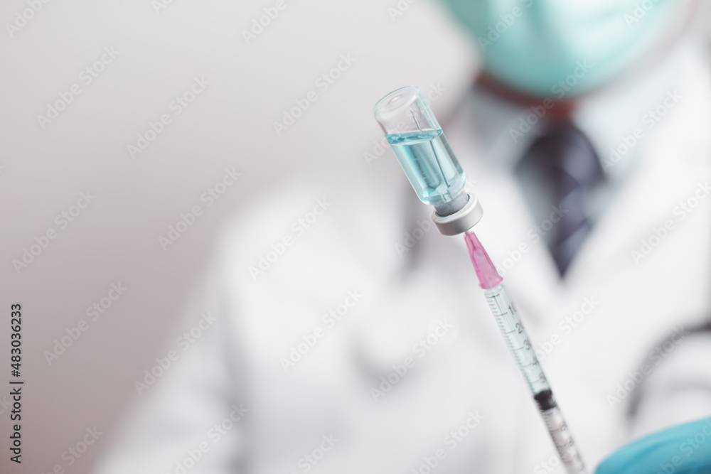 doctor or scientist in the COVID-19 medical vaccine research and development laboratory holds a syringe with a liquid vaccine to study and analyze antibody samples for the patient.
doctor or scientist in the COVID-19 medical vaccine research and development laboratory holds a syringe with a liquid vaccine to study and analyze antibody samples for the patient.