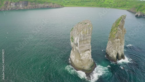 Awesome circle panorama. Huge rocks towers in teal bay, sea birds flying around
