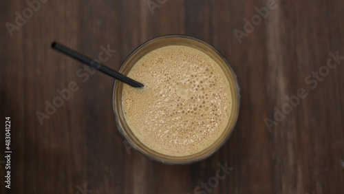 Sped-up shot of frappe bubbles popping in the froth. Traditional Greek iced coffee. photo