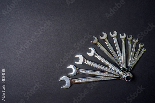 Set of wrenches on black background. Tools spanners. Technique repair, equipment for mechanical service, labor or father's day concept. Flat lay, top view, copy space
