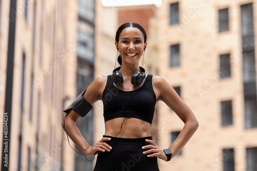 Athletic Young Woman In Sportswear Posing On City Street During Outdoor Training