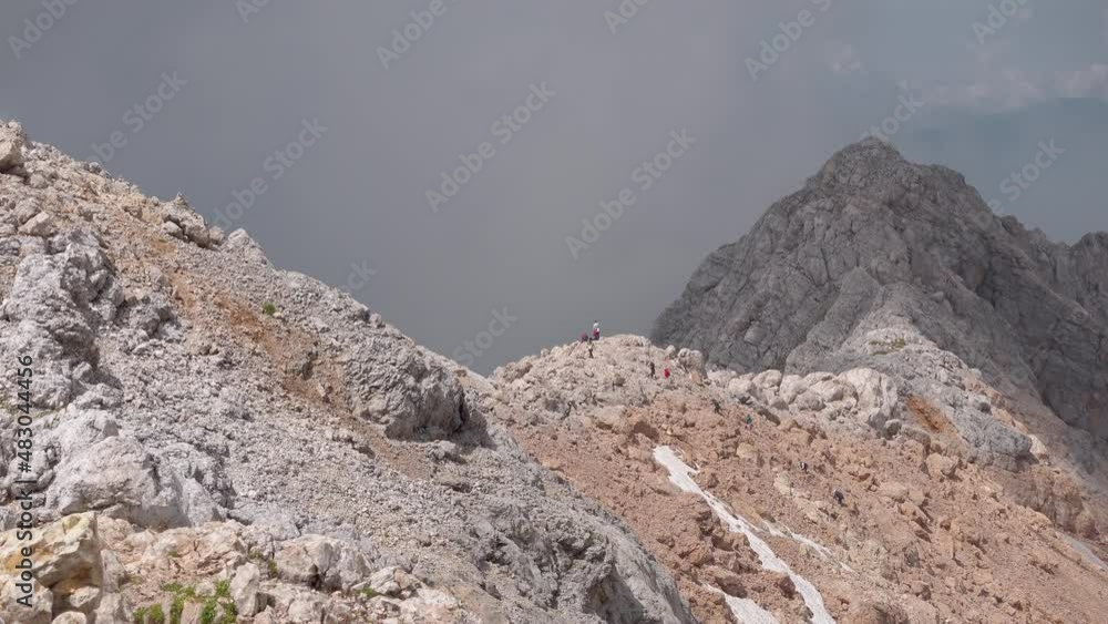 Scenic mountain pass near Fisht Mount, Adygea, Russia. People hiking in the mountains. Caucasian State Natural Biosphere Reserve named after Kh.G. Shaposhnikov. Lago-Naki plateau. Russia. Scenic mountain pass near Fisht Mount, Adygea, Russia. People hiking in the mountains. Caucasian State Natural Biosphere Reserve named after Kh.G. Shaposhnikov. Lago-Naki plateau. Russia.