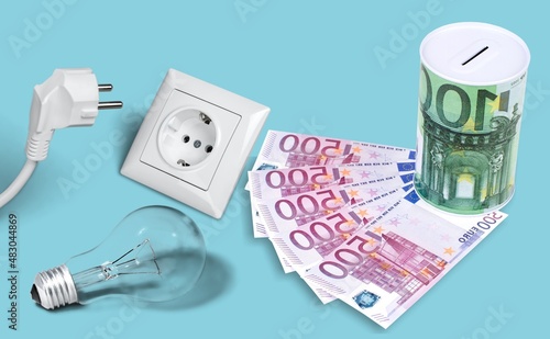 Electric plug and money banknotes. Increasing of electricity costs for residential and business users