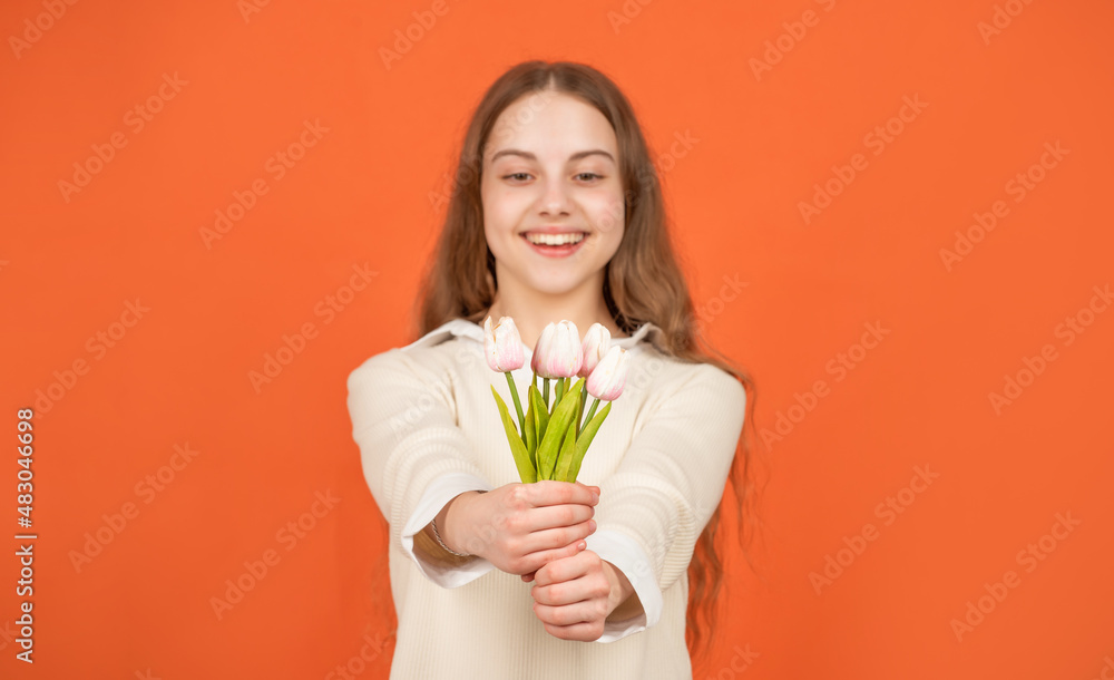 tulip flowers in hands of happy child on orange background, selective focus, mothers day tulip flowers in hands of happy child on orange background, selective focus, mothers day