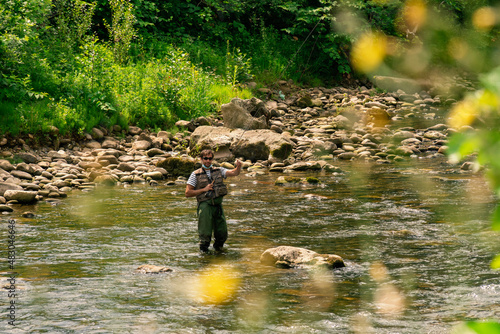 Young man fishing trouts in the river