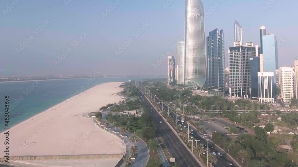 Abu Dhabi aerial skyline, beach, promenade and main road on a sunny day, going up in the sky with a drone Abu Dhabi aerial skyline, beach, promenade and main road on a sunny day, going up in the sky with a drone