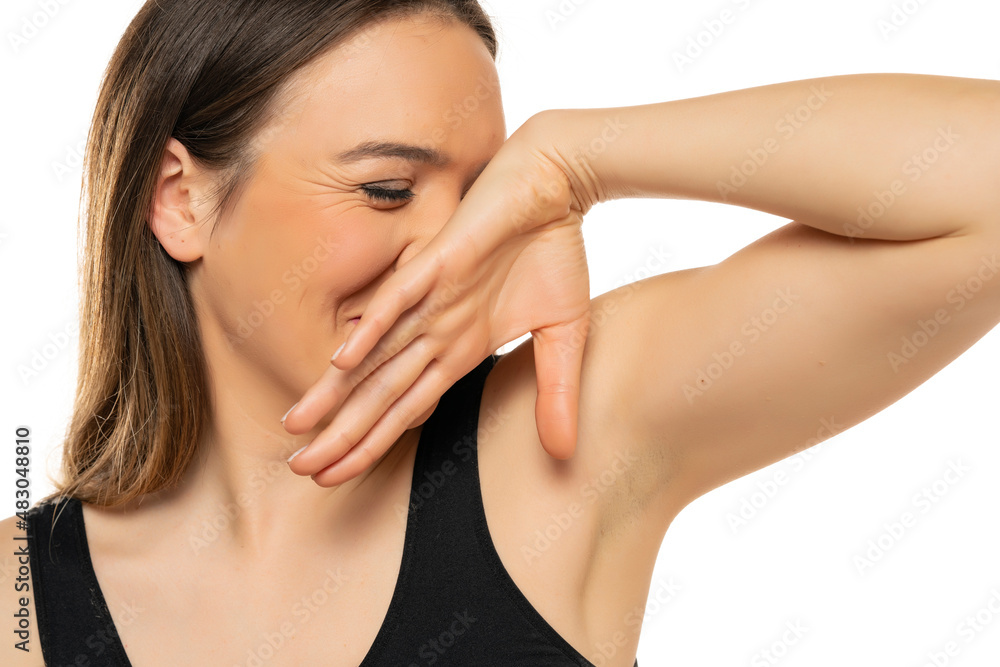 Young woman smiling and covering her face with hand Young woman smiling and covering her face with hand