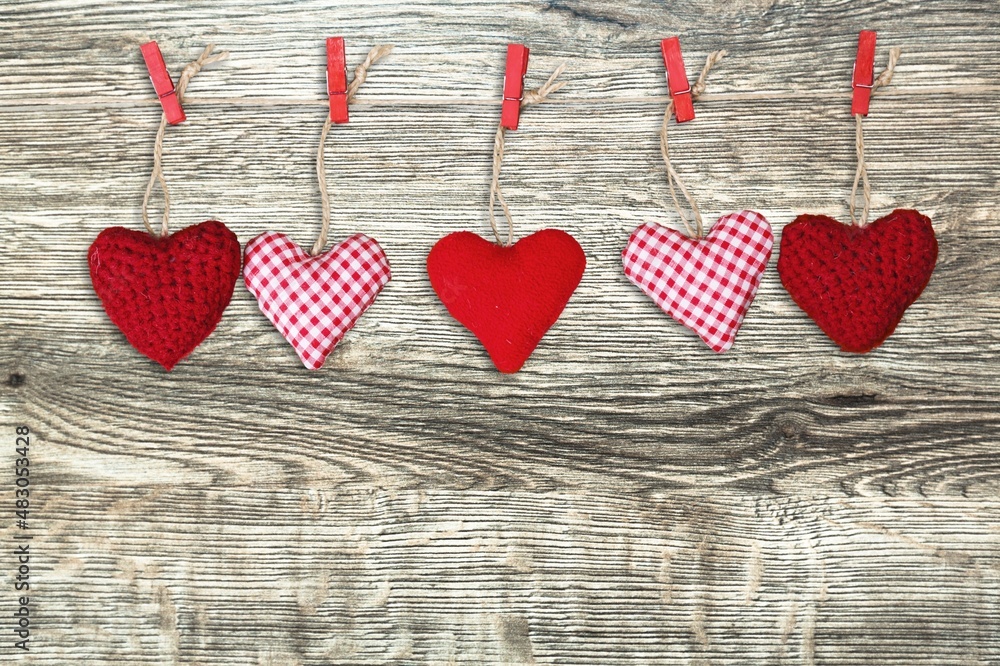 Fototapeta premium Hand made colored hearts over a wooden background