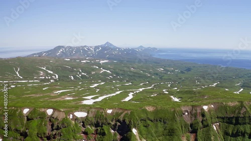 Gorgeous aerial panorama. Snowy pattern on wide endless green wilderness terrain
