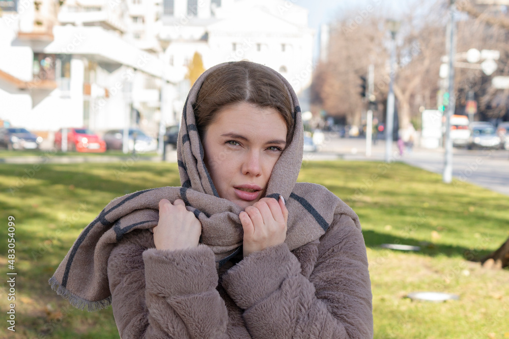Fototapeta premium Young beautiful woman on the background of the park for relaxation