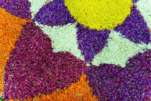 close up of colorful rangoli pattern made wiith flower petals © Muralidhara