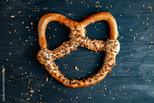 Fresh prepared homemade soft pretzels. Different types of baked bagels with seeds on a black background.