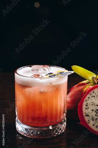 Obraz na plátně Glass of dragonfruit refresher drink on table with ice cubes
