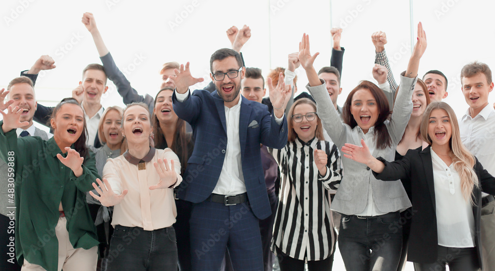 happy group of young employees with hands up