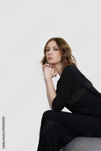 Studio shot of woman in black cotton casual outfit, short sleeves shirt and basic pants