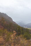 A picturesque vertical landscape view of the French Alps mountains during the rain on a cold winter day (Veynes, Chateavieux)