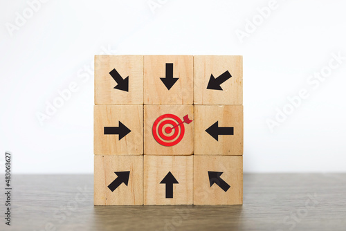 Woodblock cubes with arrow head towards the Target. Business achievement goal concept