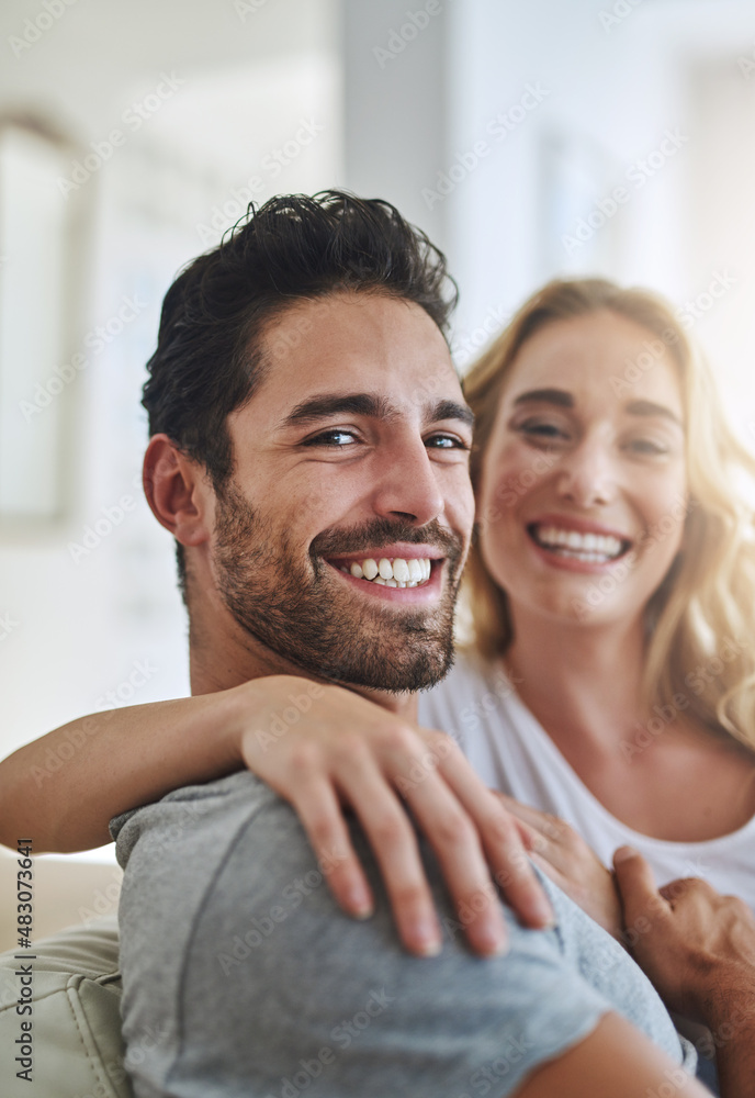 Fototapeta premium Happily married to an amazing woman. Shot of a young couple relaxing at home.