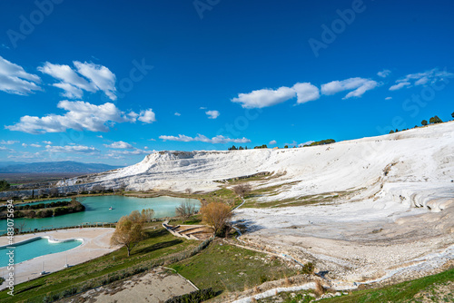 Pamukkale, meaning "cotton castle" in Turkish, is a natural site in Denizli in Turkey. The area is famous for a carbonate mineral left by the flowing of thermal spring water.