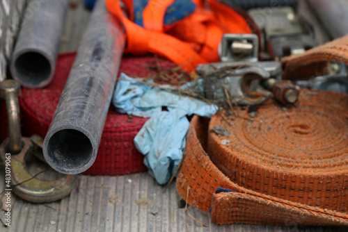 A pile of different metal tools, pipes and other pieces used in buildings. Closeup color image