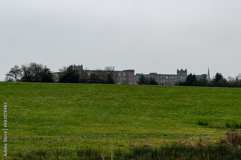 view of an old factory among fields, Heywood, Greater Manchester, England view of an old factory among fields, Heywood, Greater Manchester, England
